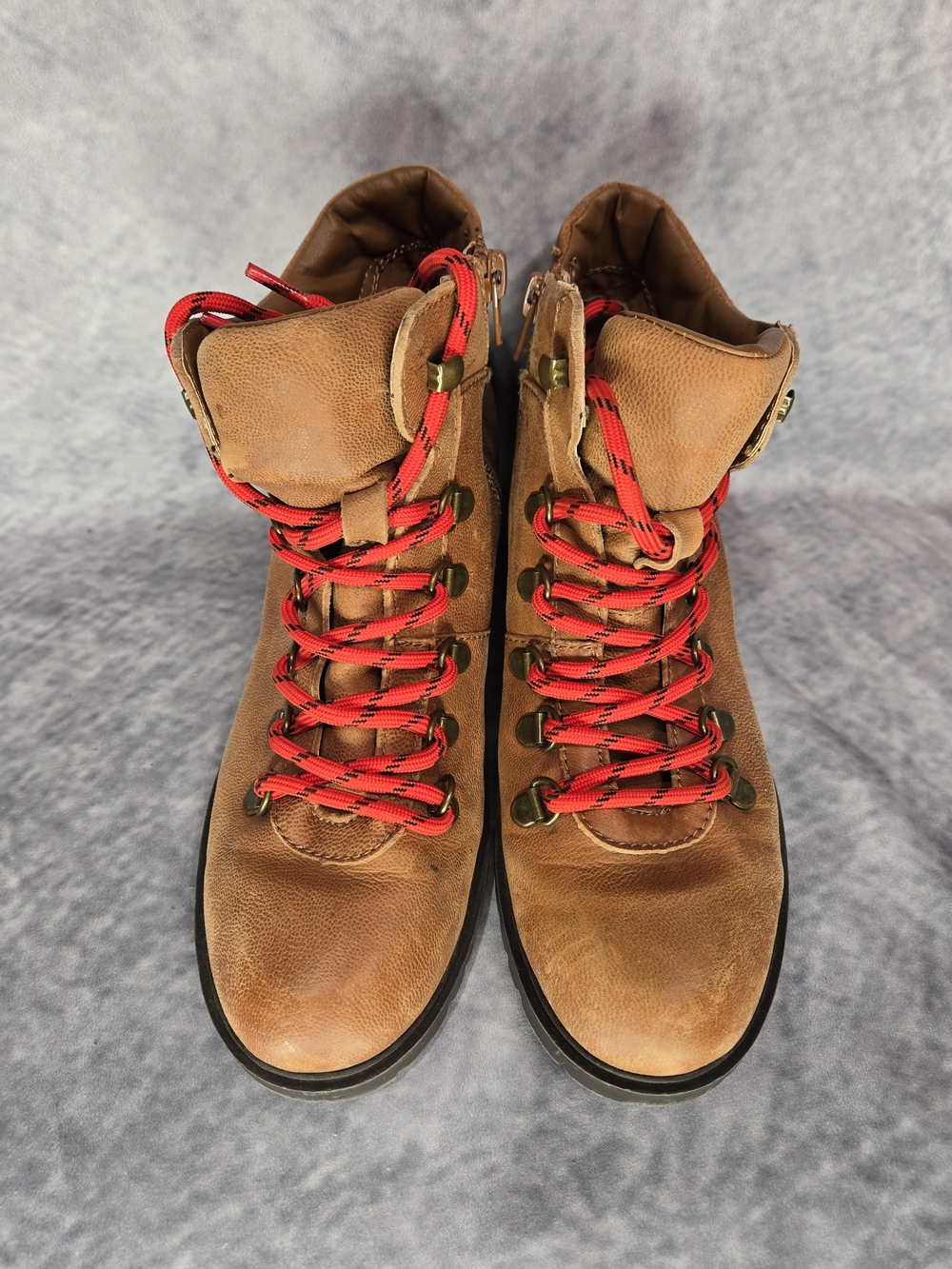 Steve Madden Lora cognac leather boots, featuring striking red and black striped